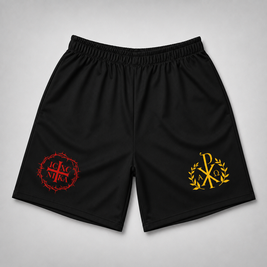 Black athletic shorts with an elastic waistband, featuring a red cross-in-crown emblem on the left leg and a gold Chi-Rho emblem on the right leg, displayed flat against a light gray background.
