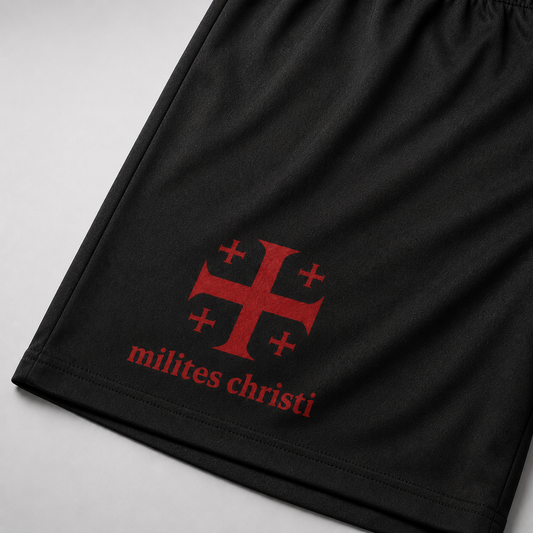 Black athletic shorts featuring a red Templar cross emblem and the text 'milites christi' printed on the side, shown against a light gray background.