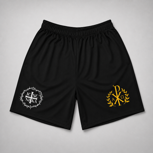 Black athletic shorts with an elastic waistband, featuring a white circular thorn crown logo on the left leg and a gold laurel wreath monogram logo on the right leg, displayed flat on a light gray background.