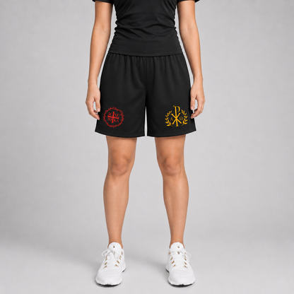 A model is shown from the waist down wearing black athletic shorts with two embroidered logos, one red and one gold, on the left and right legs. The model is also wearing a black t-shirt and white sneakers against a neutral gray studio background.