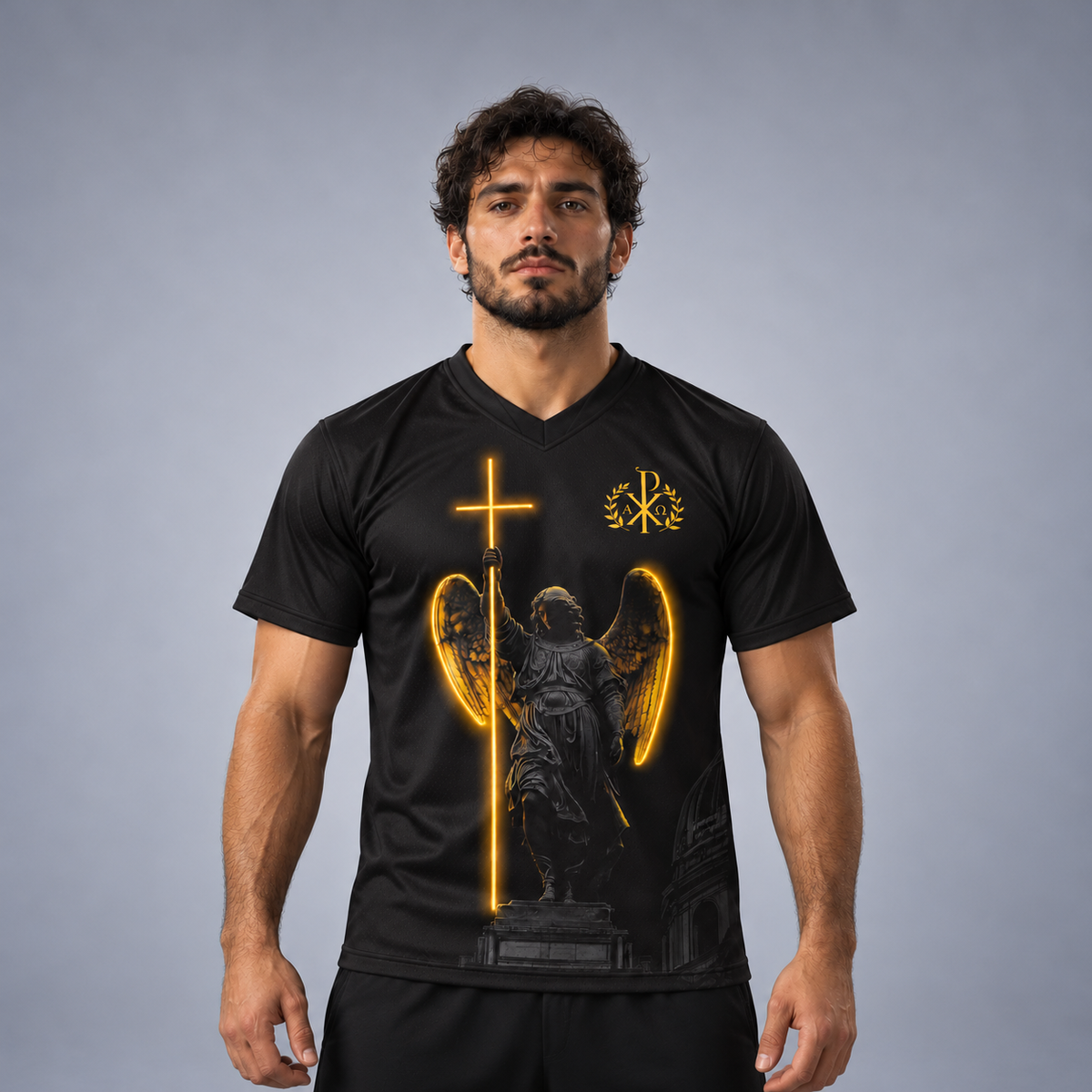 A man wearing a black V-neck athletic t-shirt with a graphic print of a winged angel holding a glowing cross, on a gray studio background.