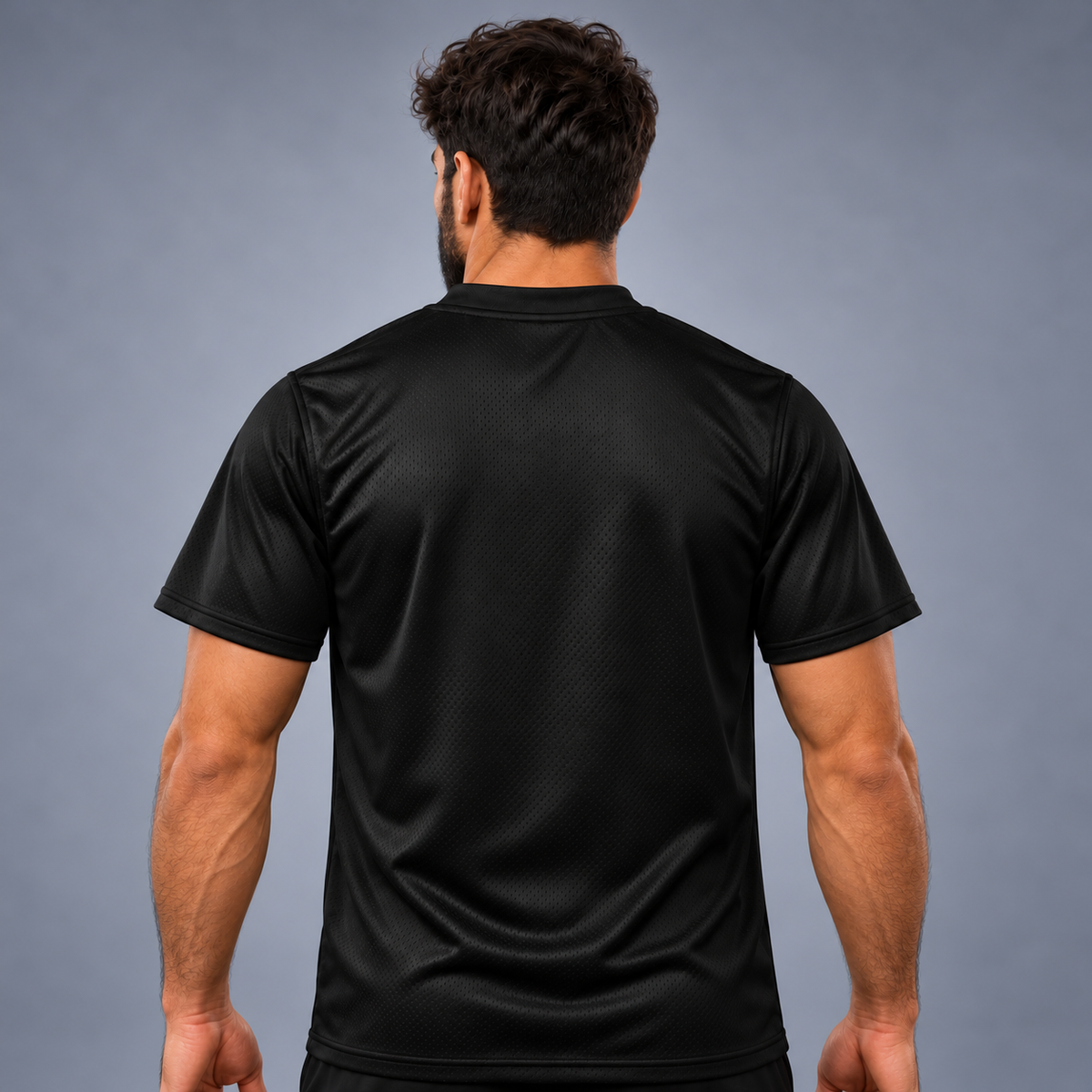 A man wearing Black short-sleeve athletic jersey shown from the back, featuring a subtle textured mesh pattern and a crew neck, photographed against a neutral gray studio background.