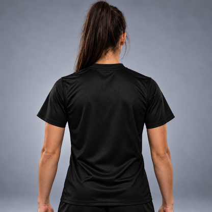 Awoman wearing Black short-sleeve athletic jersey shown from the back, featuring a subtle textured mesh pattern and a crew neck, photographed against a neutral gray studio background.