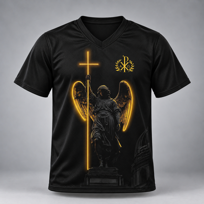 A black short-sleeve V-neck t-shirt with a graphic print of an angel statue holding a glowing golden cross, with a gold monogram logo on the upper chest, shown against a gray gradient background.
