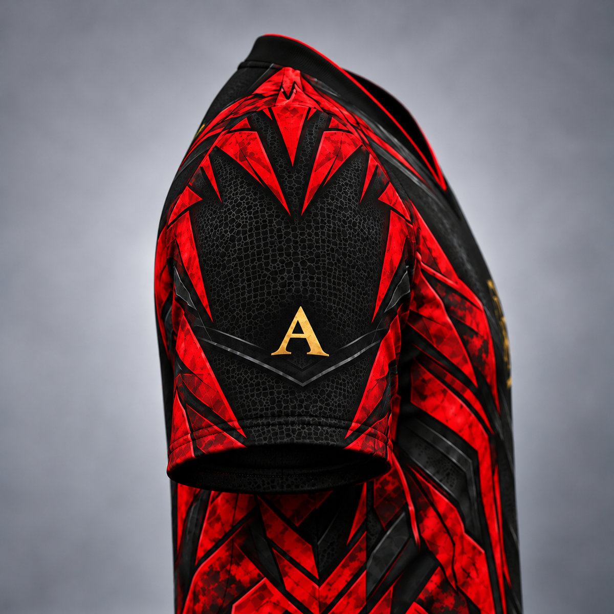 Close-up of the back of a short-sleeve athletic jersey in black and red with a textured pattern and a gold letter 'A' on the upper back, shown against a gray gradient background.