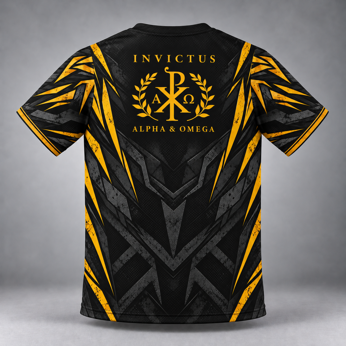 Black short-sleeve t-shirt with a gold and gray geometric graphic design, featuring the text 'INVICTUS ALPHA & OMEGA' and a Chi-Rho emblem on the back, shown against a gray studio background.