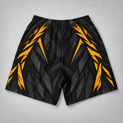 Black athletic shorts with a gray geometric pattern and bright yellow lightning-bolt accents, shown flat on a light gray background.