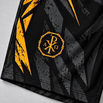 Close-up of a black athletic garment with a geometric gray pattern and bold yellow graphic accents, featuring a circular yellow monogram logo on the chest.