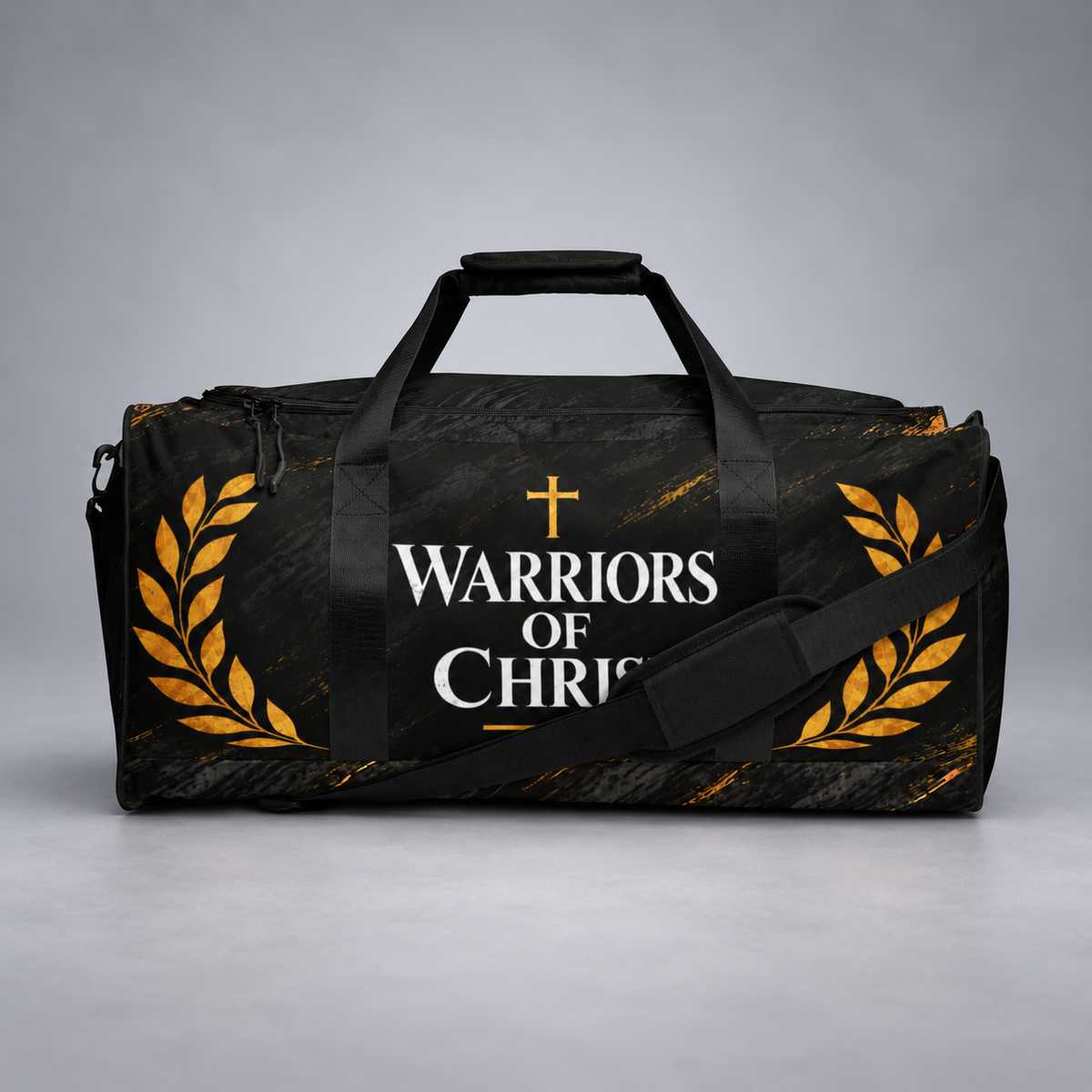 A black duffel bag with a distressed texture, featuring the text 'WARRIORS OF CHRIST' in white with a gold cross, flanked by gold laurel wreaths on both sides. The bag has black handles, a black shoulder strap, and is set against a neutral gray studio background.