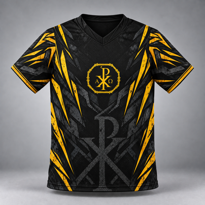 A black short-sleeve V-neck jersey with a distressed gray graphic pattern and bold yellow accents, featuring a circular Chi Rho monogram with Greek letters on the chest.