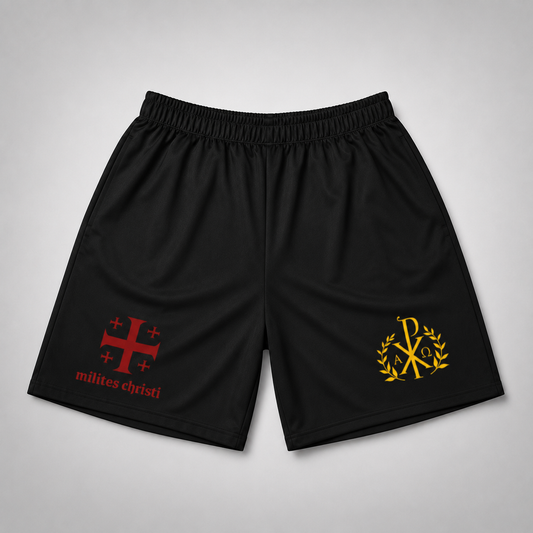 Black athletic shorts with an elastic waistband, featuring a red Jerusalem cross and 'milites christi' text on the left leg, and a gold monogram logo with laurel branches on the right leg, shown against a light gray background.