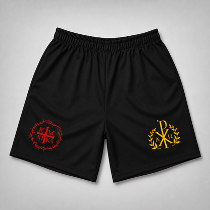 Black athletic shorts with an elastic waistband, featuring a red cross-in-crown emblem on the left leg and a gold Chi-Rho emblem on the right leg, displayed flat against a light gray background.